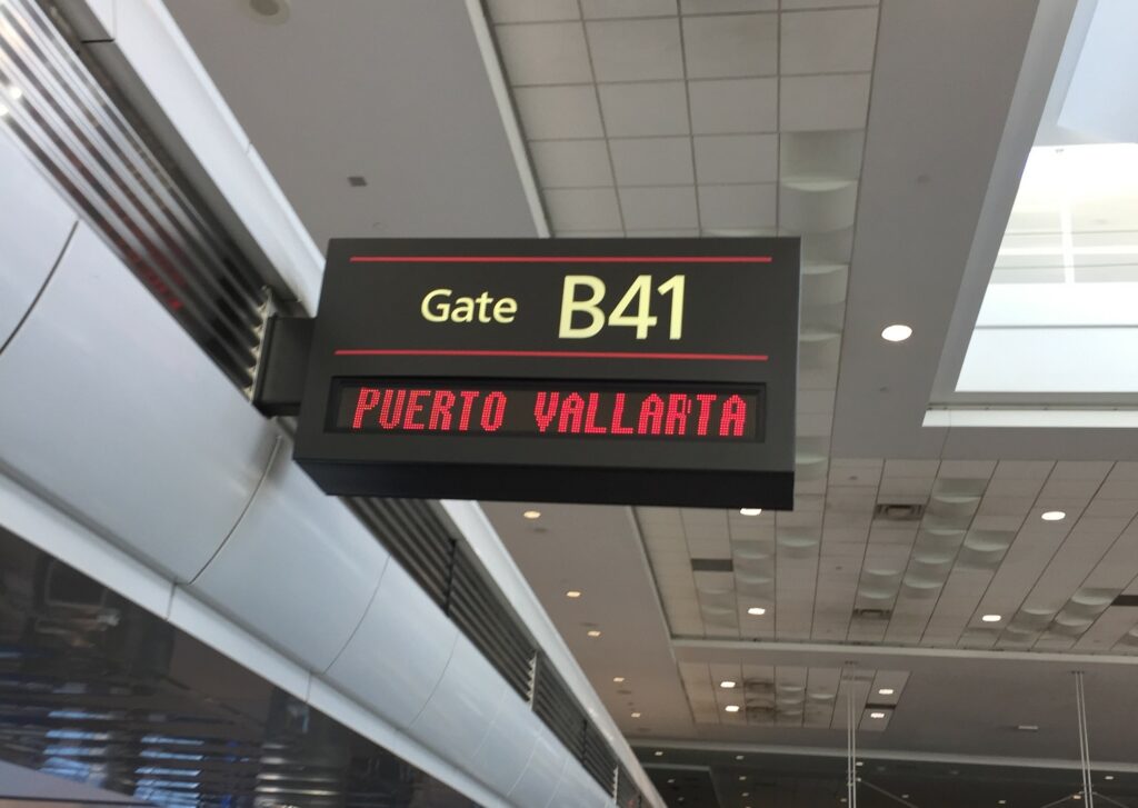 Is Mexico Safe for Travel? Airport gate showing Puerto Vallarta departure.