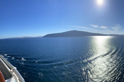 A view from the deck of a Princess ship sailing into harbor on a beautiful day